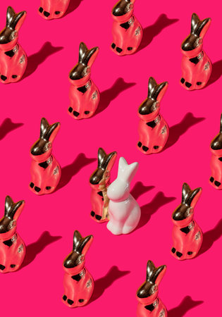 Pattern composition of Easter bunnies on hot pink background. Minimalist isometric concept.の写真素材