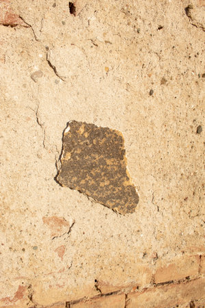 Weathered close-up of old damaged wall with peeling plaster and grunge detail, a rustic urban decay...
