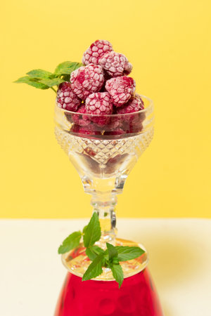 Frozen raspberry fruit with mint in a glass. Still lifeの写真素材