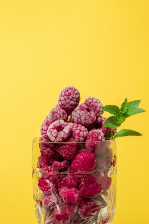 Frozen raspberry fruit with mint in a glass. Still lifeの写真素材