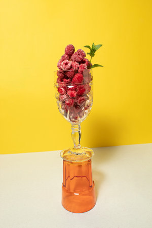 Frozen raspberry fruit with mint in a glass. Still life