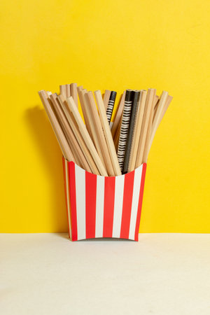 Graphite pencils in red-white box close on the yellow wall. Back to schoolの写真素材