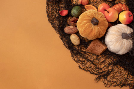 Halloween frame with party decorations of pumpkins on orange background from above. Halloween card...