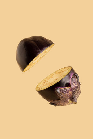 Eggplant sliced on pastel pink background. Minimal fruit concept.の写真素材