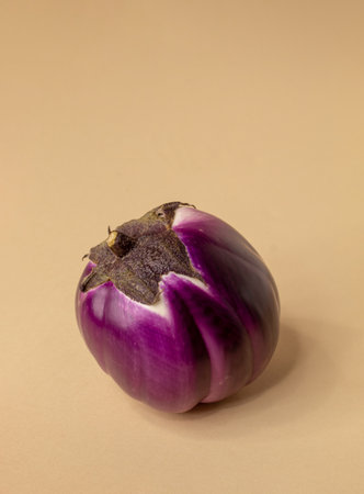 Eggplants on a beige kitchen table with black background. Still lifeの写真素材