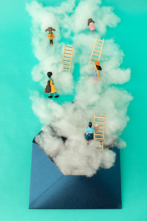 Clouds and people on a ladder coming out of an envelope. Growth, future, development concept. Minimal business composition.の写真素材