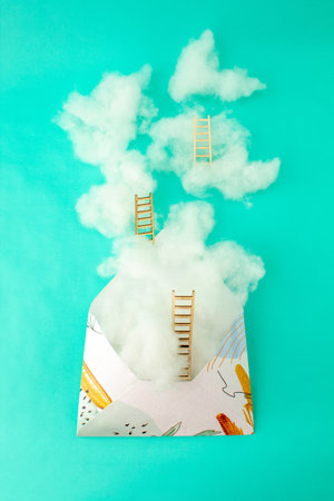 Clouds and ladder coming out of the envelope. Growth, future, development concept. Minimal futuristic composition.の写真素材