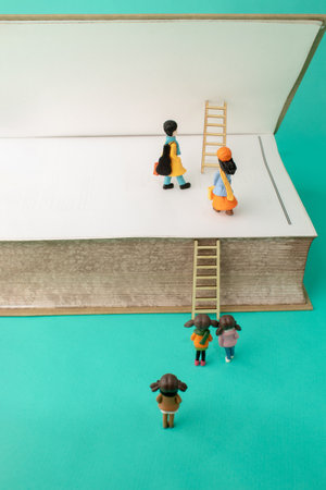 Little people on a ladder enter a big book. Growth, future, development concept. Minimal business composition.の写真素材