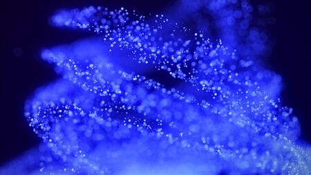 A vortex of lighting particles. A tornado of twisted glowing blue dots. Abstract digital background...