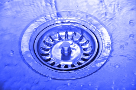 Background with splashing water in kitchen sink