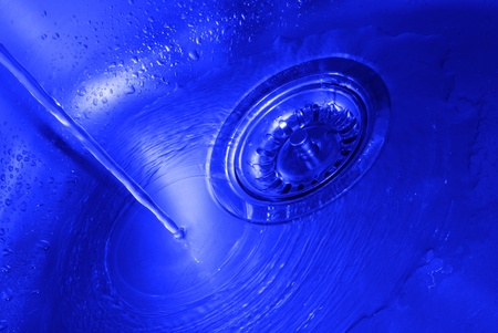 Background with splashing water in kitchen sinkの写真素材