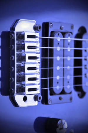 Part of an electric guitar with pickup and strings