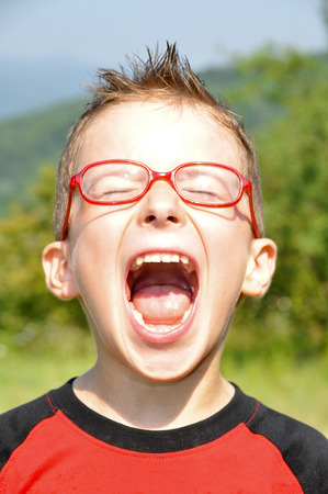 Red glasses, open mouth childrenの写真素材