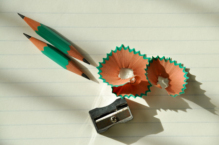 Small pencils and pencil sharpener on a white background