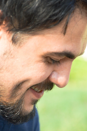 Young man with beard and smiling expression