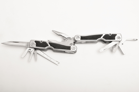 Folded multitool isolated on white background