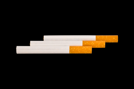 Typical filter cigarette isolated on black backgroundの写真素材