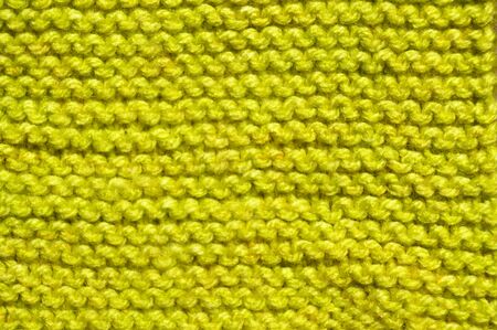 Pattern fabric made of wool. Handmade knitted fabric green wool background textureの写真素材