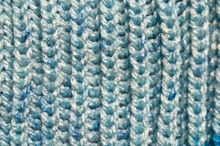 Pattern fabric made of wool. Handmade knitted fabric blue wool background texture