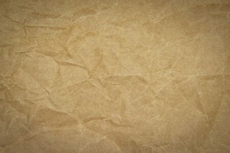 Recycled packing paper in natural beige and brown, crumpled carton textureの写真素材
