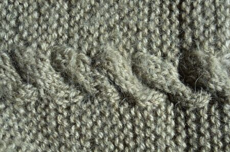 Pattern fabric made of wool. Handmade knitted fabric grey wool background texture