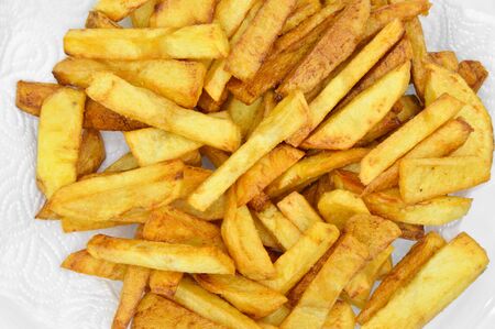 Homemade fresh and fried potatoes on plate, golden color