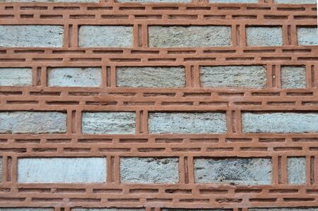 Sturdy beige and red cut stone wall, good for backgrounds, seamless lined up