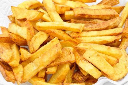 Homemade fresh and fried potatoes on plate, golden color