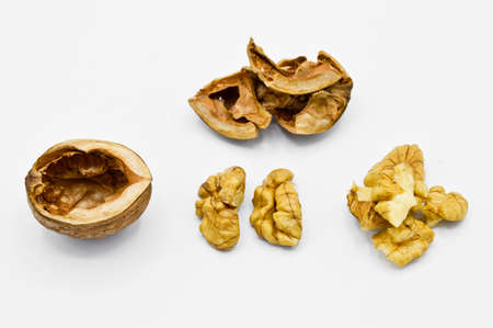 Healthy and nutritious beige brown cracked walnut grains, isolated on white background