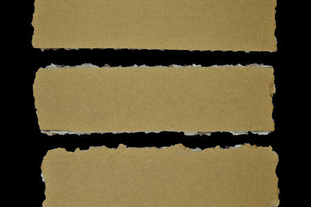 Brown and beige corrugated cardboard pieces, isolated on black background