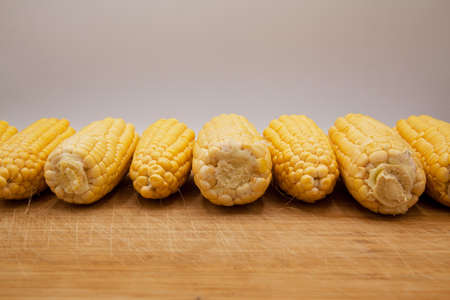 Very fresh and nutritious yellow ripe corn cobs, on bamboo wooden backgroundの写真素材
