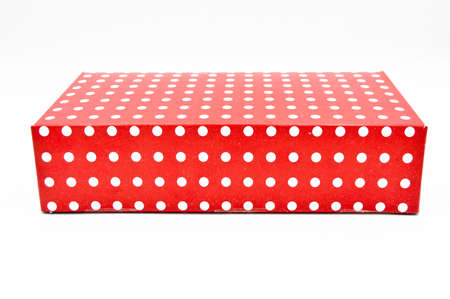 Ornate red a gift box, ideal for special occasions and Christmas, isolated on white backgroundの写真素材