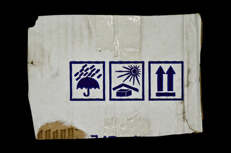 Brown and beige colored corrugated cardboard and warning signs detailの写真素材