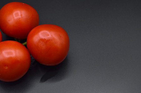 Fresh tasty tomato, all organic tomato, fresh red organic tomato, isolated on black backgroundの写真素材