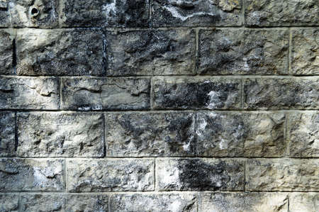 Sturdy white and gray cut stone wall, good for backgrounds, seamless lined up