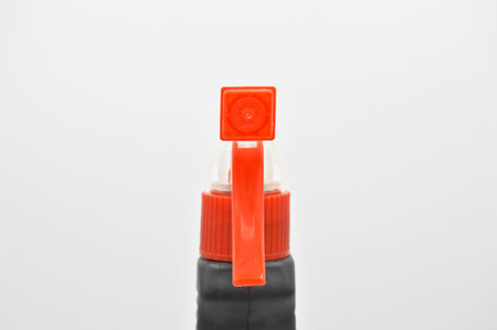 Black orange colored plastic spray detergent bottle. Cosmetic, container. Isolated on white backgroundの写真素材