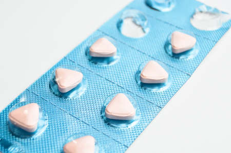 Pink pills tablet packed and used in healthy environment, isolated on white background