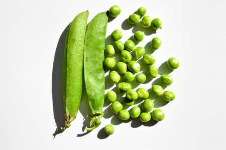 Fresh green peas and grains, nutritious green vegetables, isolated on white backgroundの写真素材