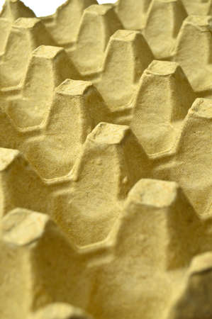 Beige and yellow empty egg carton, recyclable egg storage container made of pulpの写真素材