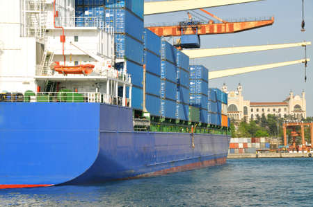 Blue colored cargo ship engaged in international logistics transportation and loading at Harem Port...
