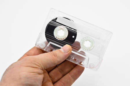 Sixty minute transparent old fashioned compact audio cassette tape, isolated on white background