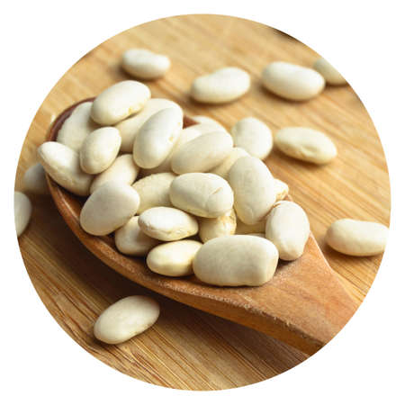 Organic healthy dried beans in wooden spoon on bamboo cutting board