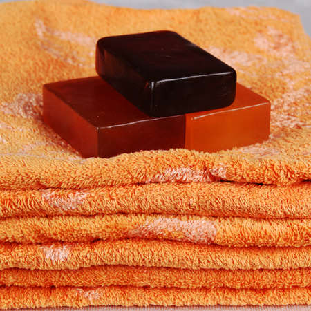 Orange and yellow aromatic, fragrant soap bars and towel