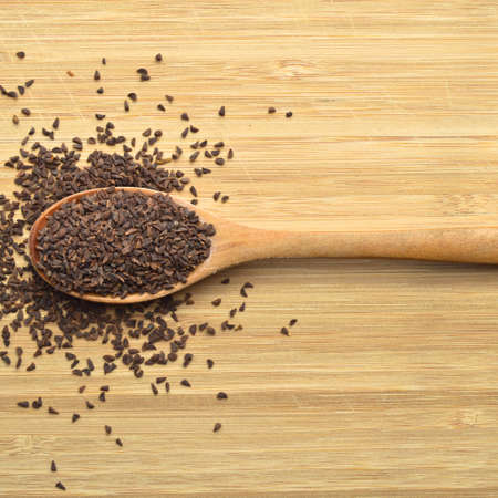 In a wooden spoon harmal seeds, harmal seeds, bamboo on cutting boardの写真素材