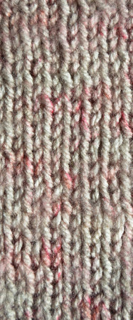 Pattern fabric made of wool. Handmade knitted fabric gray wool background texture