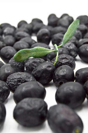 Fresh delicious black color turkish olives isolated on white backgroundの写真素材