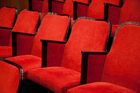 Modern cinema hall empty and red comfortable seats, movie theater seats or chairの写真素材