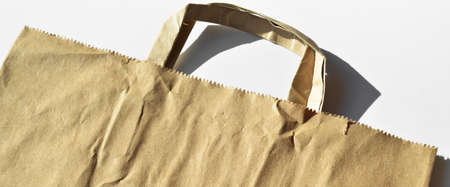 Recycled brown beige paper shopping one bag on white background. Natural Product. Recyclable paperの写真素材