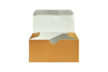 Beige rectangular cardboard box with open lid of corrugated cardboard isolated on white backgroundの写真素材
