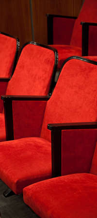 Modern cinema hall empty and red comfortable seats, movie theater seats or chairの写真素材